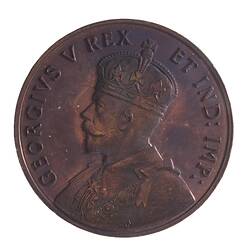 Round bronze-coloured medal with bust of King facing left, wearing crown and formal attire. Text around.