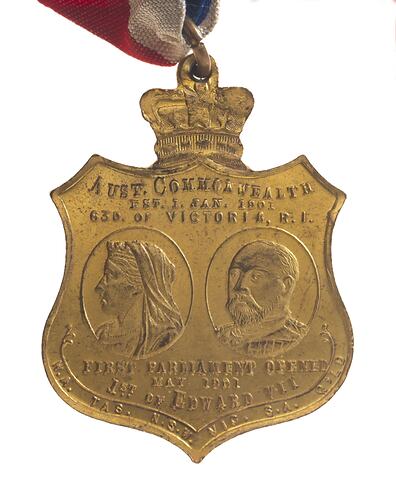 Shield shaped medal with oval portrait of woman and man. Queen Victoria and Edward VII.