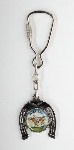 Metal keyring, upsidedown black horseshoe shape with image of horse in central disc. Silver clip ring at top.