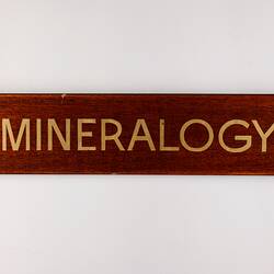 Wooden varnished  rectangular sign with gold gilt lettering.