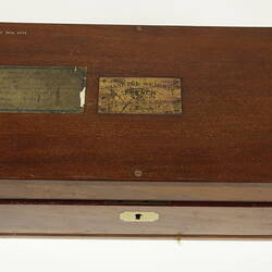 Closed box with engraved brass plate in centre of lid.