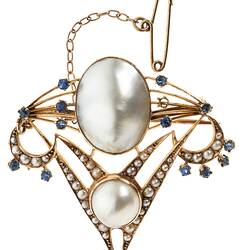 Delicate gold inverted triangle brooch with two main pearls framed by seed pearls and blue paste. A fine gold chain and pin extend from top left corner.