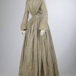 Pale grey striped silk dress with long sleeves and long skirt.