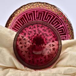 Round base of red glass epergne with gilded decoration.