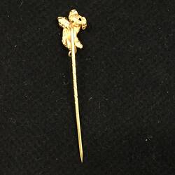 Gold stick pin with a small irregular gold nugget at the end.