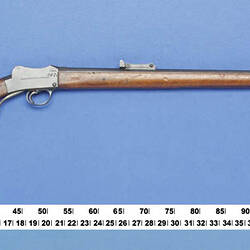 Side view of rifle with measure below.