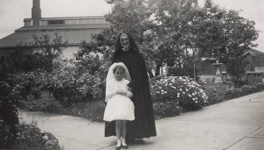 Digital Photograph - Girl Dressed for First Communion with her Aunt, a Nun, at Convent of the Little Sisters of the Poor, Northcote, 1959
