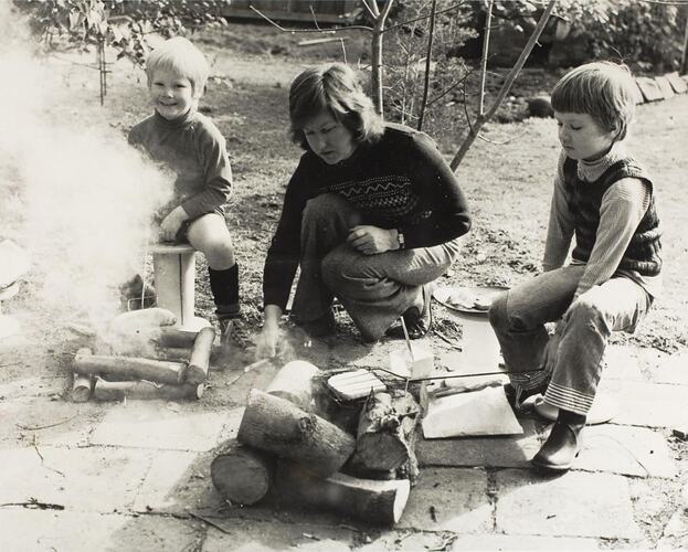 Digital Photograph - Woman with Two Boys Toasting Bread on Wood Fires, Back Yard, Toorak, 1974