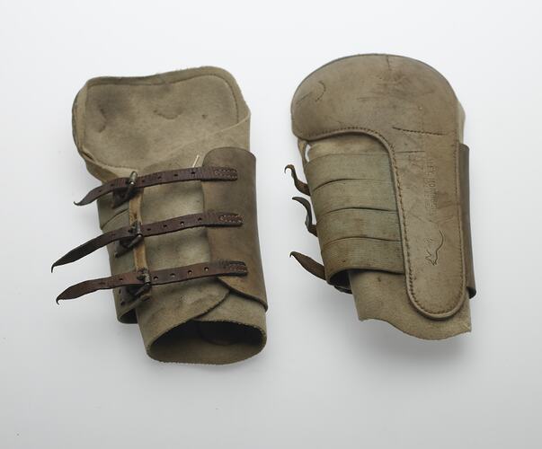 Two horse shin pads, front legs. Three leather straps, elastisized. Pads have felt base with leather on top. K