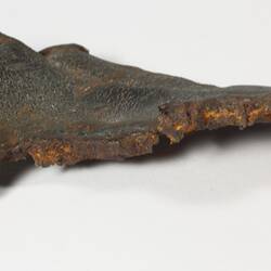 Irregular shaped piece of corroded iron, top side smooth.