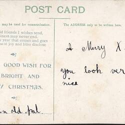Back of postcard with green and black text.