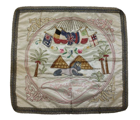 Front of embroidered panel with motifs including pyramids.