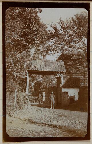 Two men standing near front gates.