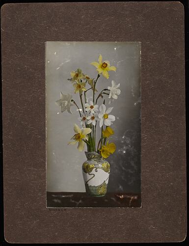 Still life of daffodil flowers in a vase.