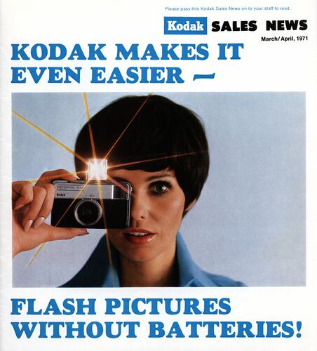 Magazine cover featuring photograph of woman using camera with flash lit up.