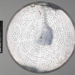Steel disc with raised dots.