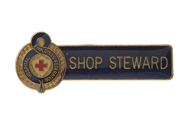 Enamel badge, red cross, blue strip with gold text.