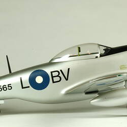 Silver model aeroplane. Lettering on side. Right profile.