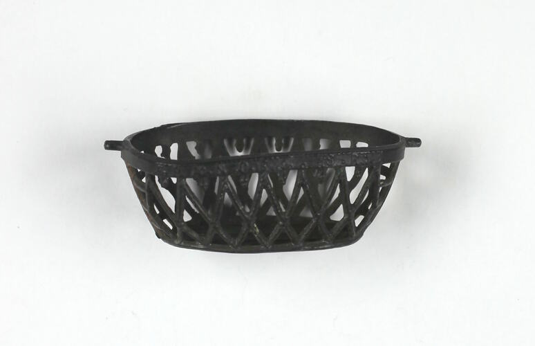 Oval metal basket, side view.
