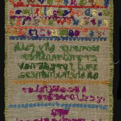 Back of embroidery sampler with coloured alphabet and verse.