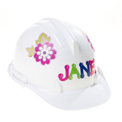 White plastic hard hat with multi-colour flower stickers on side and letter stickers on front.