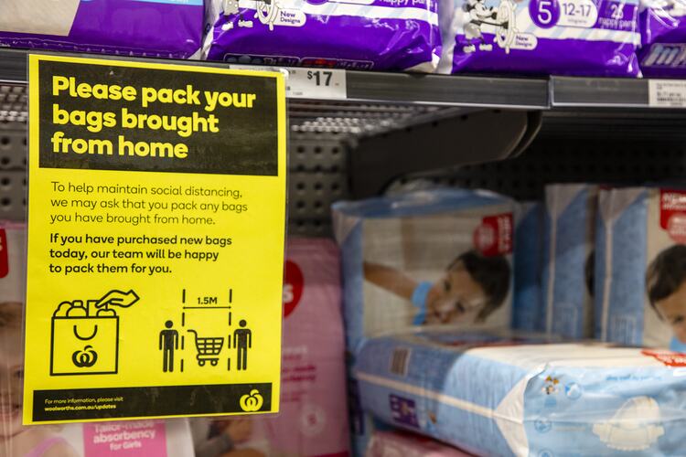 Yellow information poster sign with printed text attached to shelf with baby products.