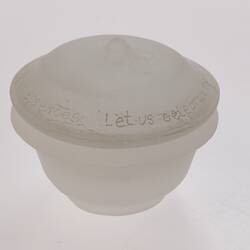 Opaque glass round spice container with lid. Narrower at base.