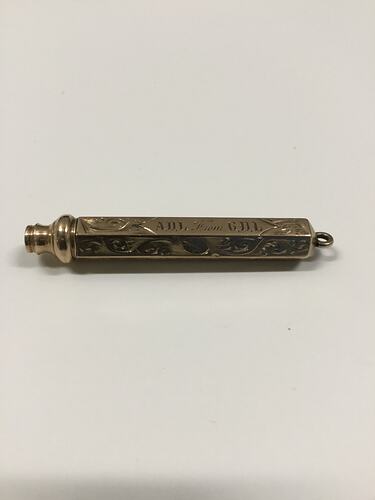 Retractable gold engraved pencil.