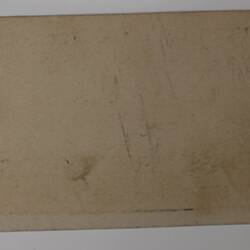 Back of off-white rectangular label.