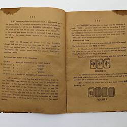 Open booklet with worn off-white pages and black printed diagrams and text.