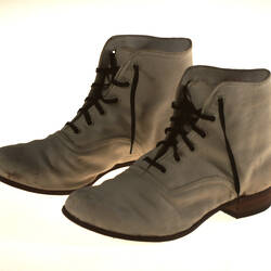 A pair of lace up canvas boots with low heals.