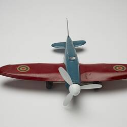 Blue and red toy aeroplane, front view.