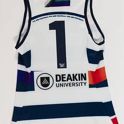 Back of women's AFLW guernsey with horizontal navy, white and rainbow stripes.