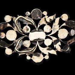 Back of silver oval brooch with gold base. Cutaway leaf motif design. Central diamond with 44 smaller diamonds around.