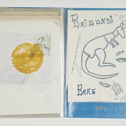 Open blue folder. Left page has yellow mark. Drawings of kangaroo, fish, turtle, boomerang on right page.