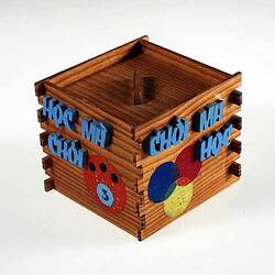 Wooden box with attached letters and coloured circles.