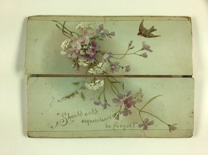 Pale grey-blue card with a four flap design. Opens horizontally. Has purple and white flowers, a bird and text at the bottom.