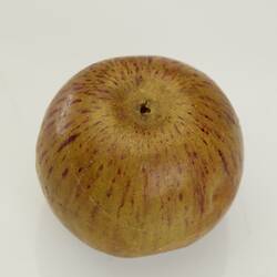 Wax apple model. Reddish yellow with reddish streaks.