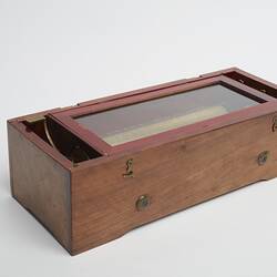 Wooden rectangular box. Glass section on top on box.