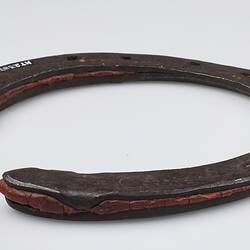 Handmade 'U' shaped metal horseshoe, with red rubber inserts.