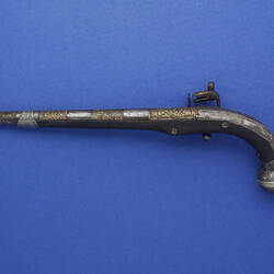 Side view of flintlock pistol. Left profile.