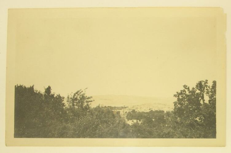 Elevated view of a town taken from a hill.