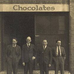 Digital Photograph - Four Men Standing outside Bush's Confectionery Factory, Richmond, circa 1935