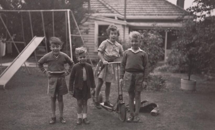 Digital Photograph - Girl on Scooter with Two Boys and Girl in Backyard, Swing Set & Slide in Background, Canterbury, 1960