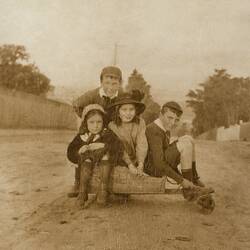 Two Boys & Two Girls Crowded onto Wooden Billy Cart on Street, Malvern, 1912