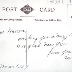 Reverse side of postcard with handwriting.