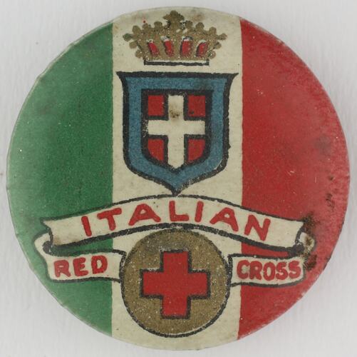 Round green, white and red badge with cresent.