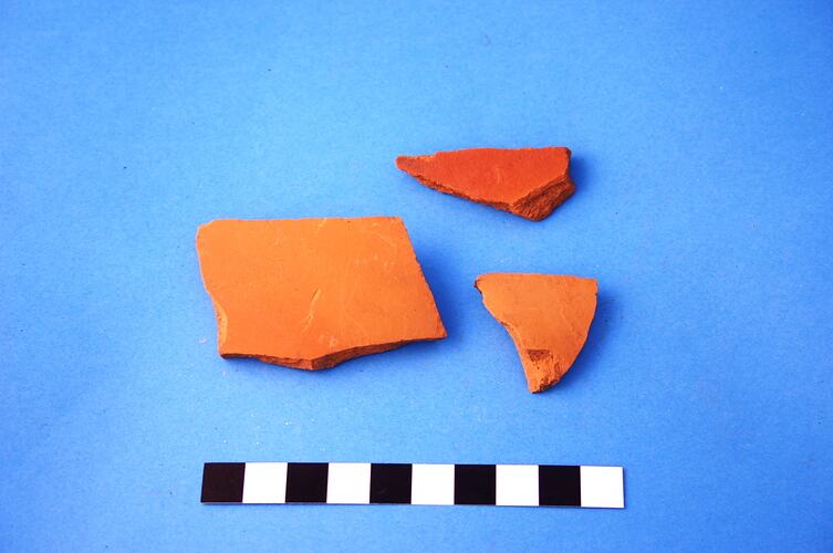 Three fragments of unglazed ceramic plant pot.