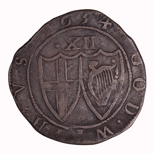 Coin, round, within a beaded circle two conjoined shields; one has St. George cross, the other the Irish harp.