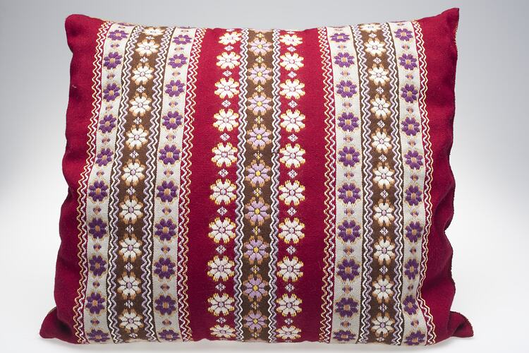 Maroon, brown, and white striped cushion, flower pattern.